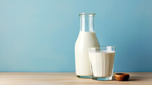 On A Pastel Background, A Bottle And Glass Of Milk Rest On A Wooden Table, With Ample Space For Your Advertising Message