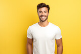 Fototapeta Kosmos - Portrait of a happy young male with a positive smile, and white teeth, looking happily at the camera, white t shirt mockup, blank white t-shirt mockup