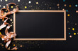 © barmaleeva - Black board, decorations and confetti on black background. AI generated