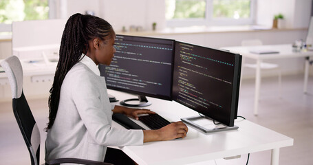 Wall Mural - african american coder using computer at desk