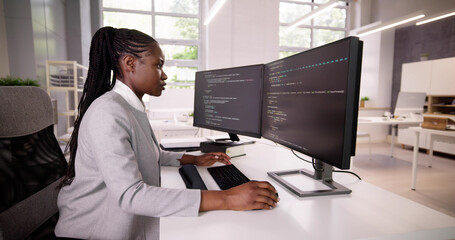 Canvas Print - African American Coder Using Computer At Desk