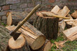 columnar sawn firewood and an ax stuck in them