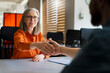 © Maria Vitkovska - Smiling confident business people hand shaking after deal, working together in modern office. Meeting, teamwork, successful business. Job interview, recruitment concept