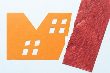 Canvas Print - machine-cut orange paper with window-like cutouts and a sample of textured red crafting paper nearby on white