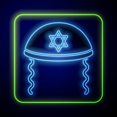 Sticker - Glowing neon Jewish kippah with star of david and sidelocks icon isolated on blue background. Jewish yarmulke hat. Vector