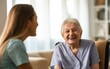 © Jan - An elderly woman smiling at a nurse in nursing home