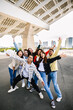 © Xavier Lorenzo - Happy young group of teenager friends having fun together outdoors. Millennial diverse friends screaming while taking photo together, enjoying free time in city street. Friendship and youth community