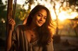 A Filipino woman slowly rocks on a swing the sun setting behind her. Her dark hair is pulled up in a bun her olive skin glowing in the soft light. She takes a deep breath lulled into