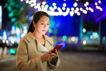 Poster - Woman use mobile phone in city at night