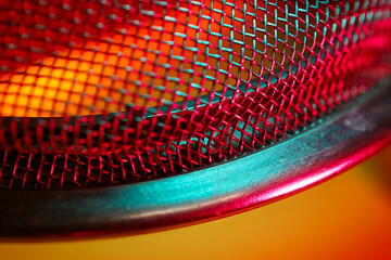 Wall Mural - Partial close up view of tea strainer illuminated with colorful lighting.