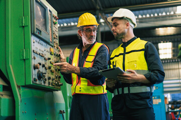 worker and engineer using tablet computer for inspection and checking production process on factory station