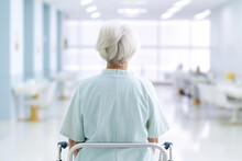 Back View Of An Aged Woman Sitting In The Chair In Hospital