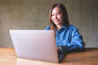 © Farknot Architect - Portrait image of a young woman working on laptop computer