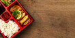 Top view Japanese food bento box set with tonkatsu and tempura, Rice Salad and Main Course. Japanese food isolated on wood background