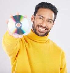 Poster - Man, cd and smile in studio portrait for music, tech or software for data, info or sound by white background. Student guy, happy model and retro disk storage or dvd for film, multimedia or movie