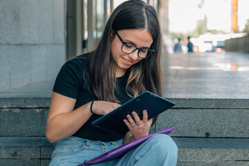 Wall Mural - teen girl with tablet on school stairs