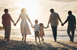 © Mumtaaz D/peopleimages.com - Beach, sunset and back of family holding hands in nature for travel, bond and fun together. Rear view, love and children with parents, grandparents and walking at sunrise on holiday adventure