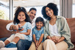 © Mumtaaz D/peopleimages.com - Remote, relax and happy family watching tv, movie or cartoon in living room on sofa for kids entertainment. Love, lounge and people in house change channel for choice, home film or television series