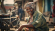 © Sasint - Portrait of an old lady sitting on a good in an African street