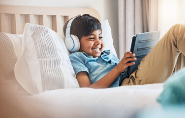 Wall Mural - Child, tablet and smile with headphones on bed for online games, watch movies or play educational app. Happy boy kid listening to multimedia, music or streaming cartoon in bedroom on digital tech