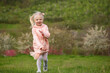 © somemeans - Happy Joyful little girl in pink outfit running through the meadow. Child rejoices in warm spring. Carefree childhood