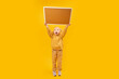 © somemeans - Little surprised girl in yellow suit holds blank board high above her head. Yellow background. Copy space.
