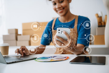 Wall Mural - Young woman holding a smartphone, tablet showing payment success and credit card with yellow parcel box as online shopping concept