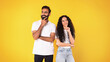 © Prostock-studio - Pensive positive middle eastern couple thinking on yellow background
