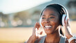 © Mumtaaz D/peopleimages.com - Headphones, mockup and black woman at fitness training or outdoor workout for health wellness and enjoy music. Smile, African and athlete or person streaming audio or radio for exercise in a park