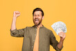 © Prostock-studio - Lucky winner. Overjoyed middle aged man holding money cash in hands, euphoric male celebrating big profit