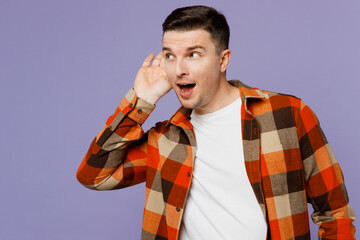Wall Mural - Young curious nosy man he wearing checkered shirt white t-shirt casual clothes try to hear you overhear listening intently isolated on plain pastel light purple background studio. Lifestyle concept.