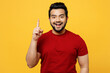 © ViDi Studio - Young insighted smart proactive happy Indian man he wears red t-shirt casual clothes holding index finger up with great new idea isolated on plain yellow orange background studio. Lifestyle concept.