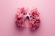 Elevate wellness with human lungs, flowers, and plants on monochrome pink background. Blossoming lung health concept: Nature's harmony unveiled.