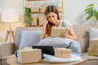 © joyfotoliakid - Asian women SME freelance working with packaging startup entrepreneur small business owner at home,Online business seller packaging and delivery concept