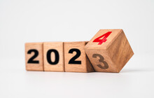 Flipping Of 2023 To 2024 On Wooden Block Cube For Preparation Merry Christmas And Happy New Year Change And Start New Business Target Strategy Concept.