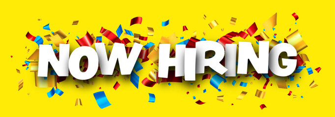 Wall Mural - Now hiring sign with colorful cut out ribbon confetti on yellow background.