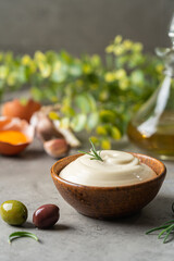 Poster - Bowl of Homemade mayonnaise sauce with olives, ingredients and herbs for cooking