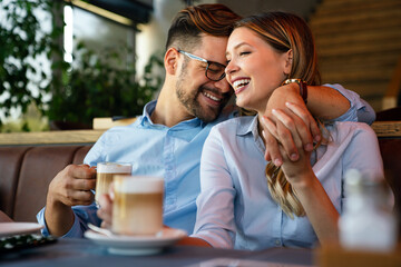 Wall Mural - Romantic loving couple drinking coffee, having a date in the cafe.