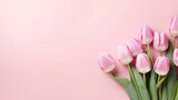 Fototapeta Tulipany - Greeting card of bouquet of pink tulips on a pastel pink background with copy space