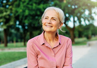 Wall Mural - woman outdoor senior happy retirement elderly portrait female active park smiling old fun nature happiness mature lifestyle beautiful bench vitality