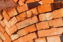 Many Red Bricks. The Bricks Is Used In Construction. Bricks Material. Construction Concept