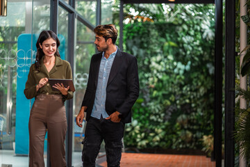 Wall Mural - business partners walking down in office building and talking