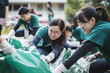 © duyina1990 - Group of young volunteers helping to keep nature clean and picking up the garbage from a sandy shore.