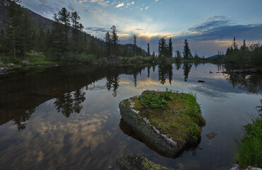 Poster - Russia. South of Siberia. Western Sayan. Panoramic view of a high-altitude lake surrounded by harsh rocks from a mountain pass in the Ergaki Natural Mountain Park.