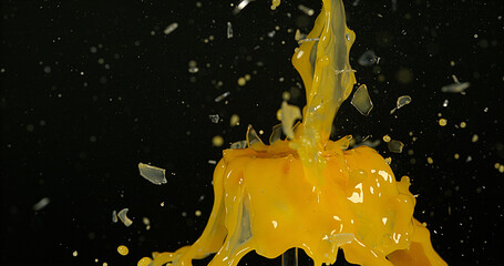 Wall Mural - Glass of Orange Exploding against Black Background