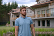© Евгений Шемякин - Portrait of happy young man standing in the garden outside his luxury home and smiling and relax outside