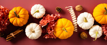 Row Of Pumpkins, Fall Flowers, Decorations, Walnuts, Cinnamon Sticks On Dark Red Background. Flat Lay, Top View. Autumn, Fall, Thanksgiving Day, Harvest Concept.