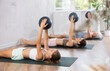 © JackF - Three generations of women perform softball exercises lying on floor, workout for beautiful figure, toned body. Bodyflex course