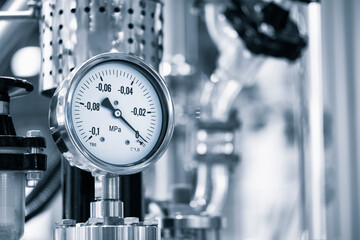 Industrial  concept. equipment of the boiler-house, - valves, tubes, pressure gauges, thermometer. Close up of manometer, pipe, flow meter, water pumps and valves of heating system in a boiler room.