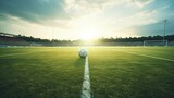 Fototapeta Fototapety sport - A soccer ball on a grassy field in a soccer stadium.